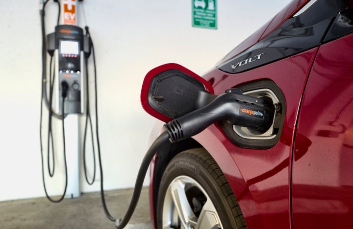 A Chevrolet Volt hybrid car charging at a ChargePoint charging station at a parking garage in Los Angeles.