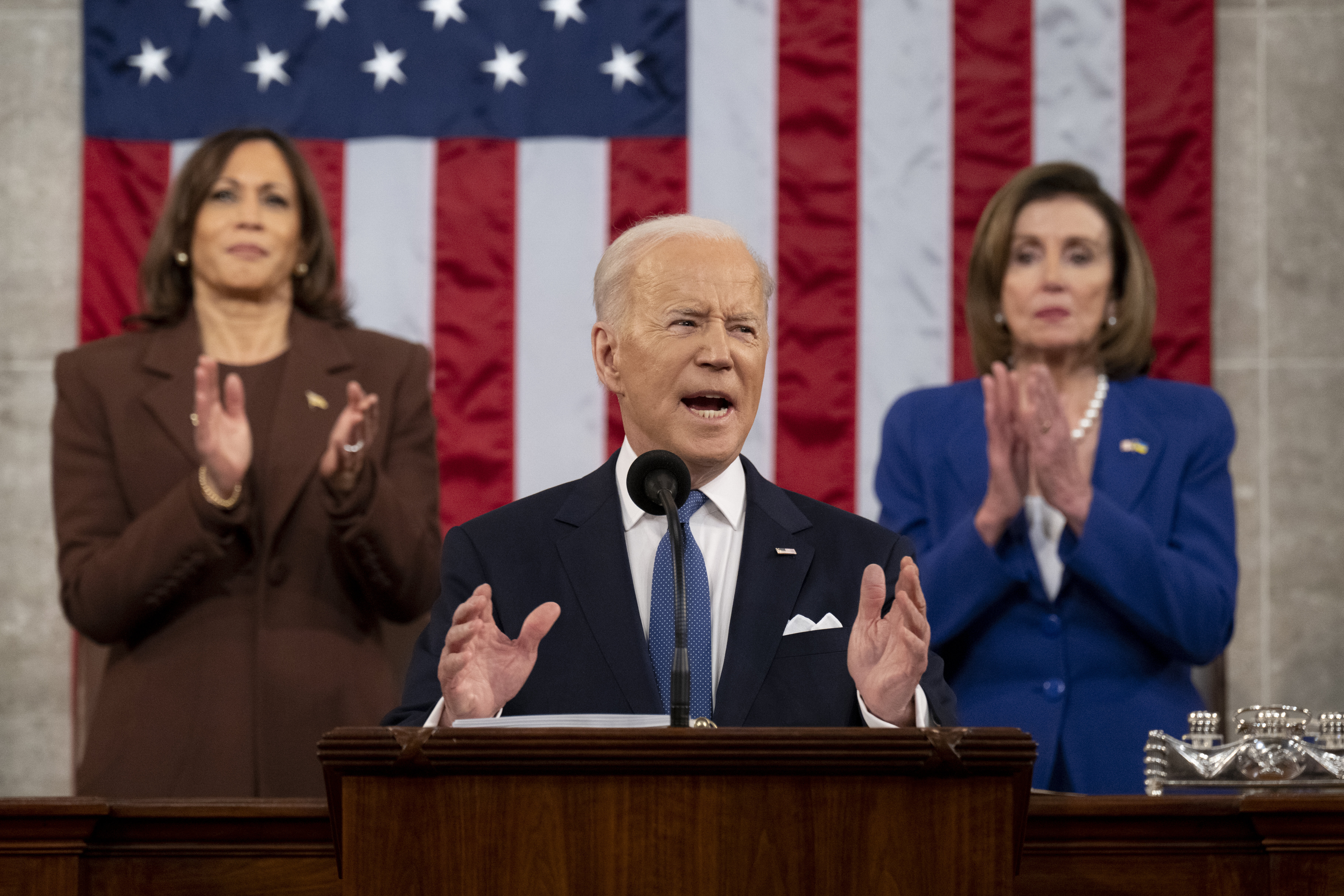 Joe Biden delivers SOTU address, with Kamala Harris, left, and Nancy Pelosi, right, applauding behind him.