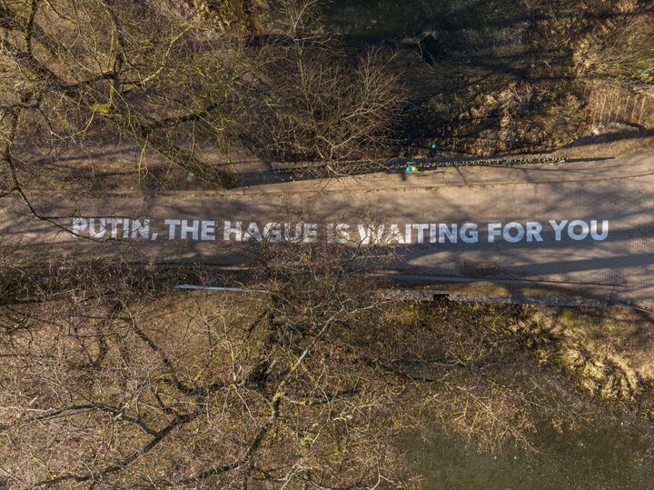A sign that reads “Putin, The Hague is waiting for you” is seen outside the Russian embassy in Vilnius, the capital of Lithuania.