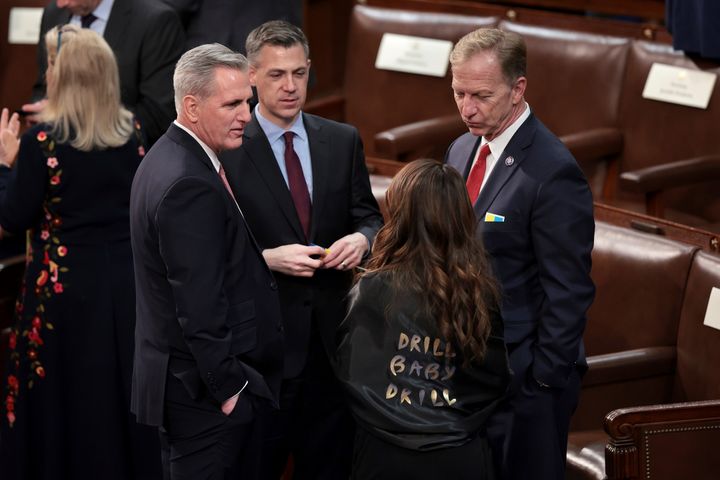 Rep. Lauren Boebert wears a shawl with "Drill Baby Drill" as she speaks with House Minority Leader Kevin McCarthy (R-Calif.), left, and other Republicans on the House floor before President Joe Biden arrives to deliver his State of the Union address on March 1.