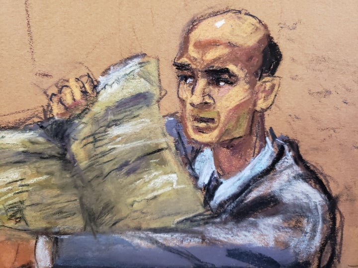 Former New York Times editorial page editor James Bennet holds up a copy of the newspaper as Sarah Palin watches during her defamation trial on Feb. 9.