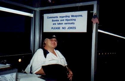 The author notes: "Louie made a living joking about airport security. Right before this picture was taken in the Atlanta airport in 2002, Louie mentioned something to the security guy, who didn’t recognize him. The security person asked, 'What, do you think you’re a comedian?' Louie responded, 'Yeah, actually. A pretty good one, too.'”