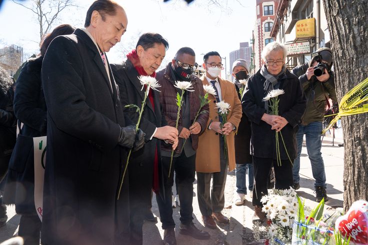Asian American community leaders place flowers on a memorial for murder victim Christina Yuna Lee after an anti-Asian hate rally in Sarah D. Roosevelt Park on Feb. 15, 2022, in New York. 