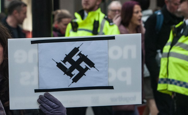 A placard at the Worldwide Rally for Freedom anti vaccines protest passes by Oxford Circus on November 20, 2021 in London.