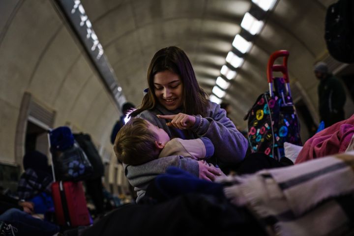 Lena from Kyiv, takes care a child named Max, 3, in a subway station where civilians are taking shelter from Russian air raids in Kyiv, Ukraine.
