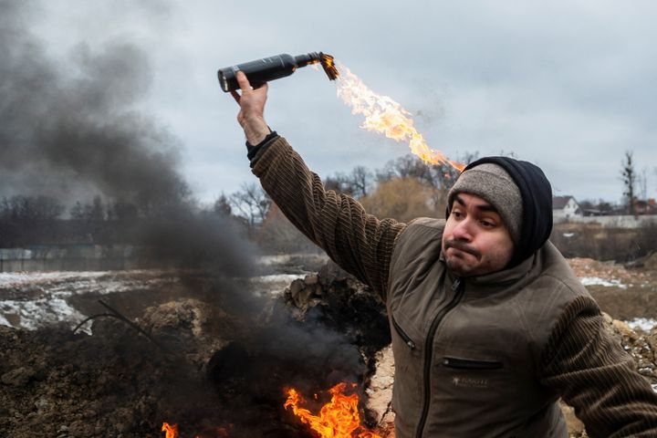 A civilian trains to throw Molotov cocktails to defend the city