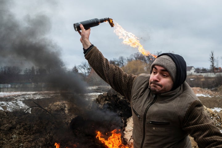 A civilian trains to throw Molotov cocktails to defend the city