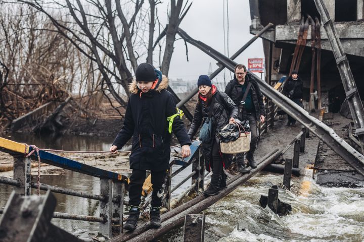 Civilians cross the shelled bridge in Irpin on March 2, 2022, in Irpin, Ukraine