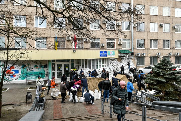 Locals of Zaporizhzhia prepare and carry sand bags inside and outside of the hospital so that it is less affected by the Russian attacks, in Zaporizhzhia, Ukraine