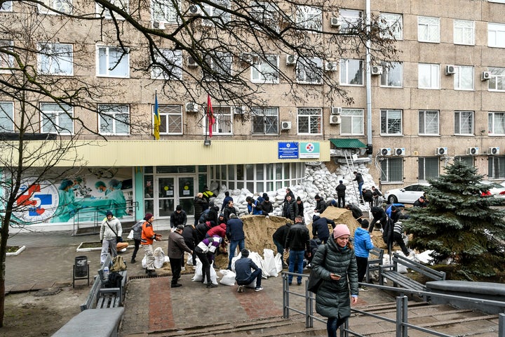 Locals of Zaporizhzhia prepare and carry sand bags inside and outside of the hospital so that it is less affected by the Russian attacks, in Zaporizhzhia, Ukraine