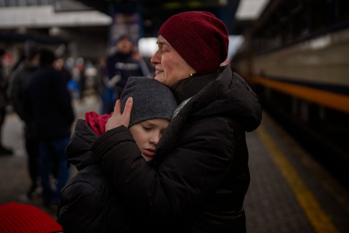 Tanya, 38, cries with her son Bogdan, 10, before getting a train to Lviv at the Kyiv station, Ukraine, Thursday, March 3, 2022. (AP Photo/Emilio Morenatti)