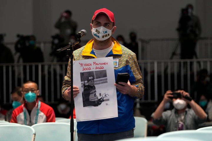 A Canadian journalist working for the Kyiv Post held a photo of Yevhen Malyshev during a news conference at the 2022 Winter Paralympics in Beijing on Wednesday. The International Paralympic Committee had decided to allow Russian and Belarusian athletes to compete only as neutral athletes but reversed course Thursday to ban them altogether.