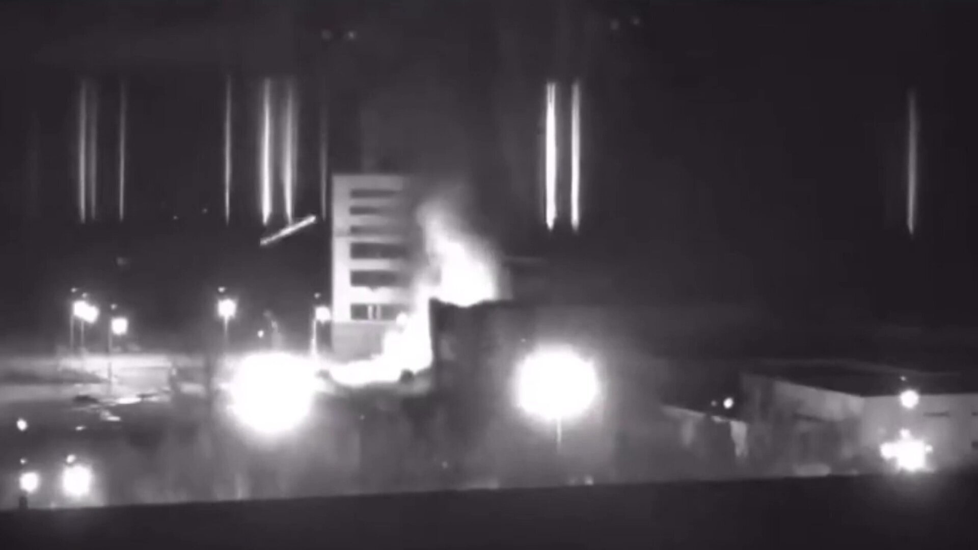 Black-and-white video footage shows power plant on fire.