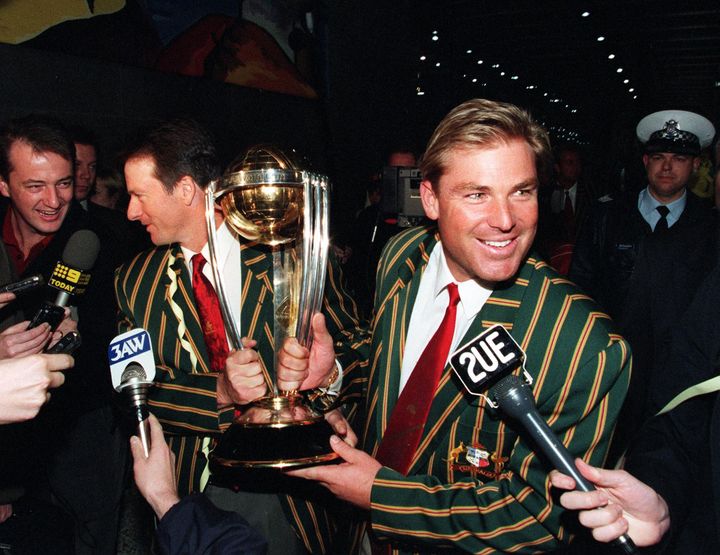 Shane Warne and teammate Steve Waugh proudly display the World Cup trophy in 1999