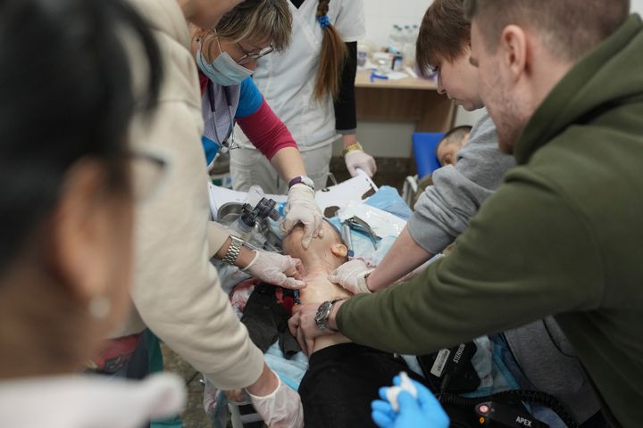 Medical workers unsuccessfully try to save the life of 18-month-old Kirill, who was fatally wounded by shelling on March 4.