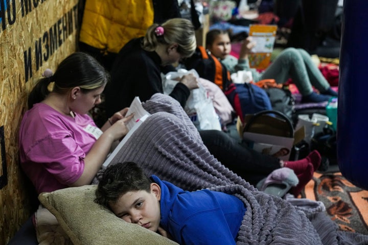 People lie on the floor in the improvised bomb shelter in a sports center that can accommodate up to 2000 people on Feb. 27.