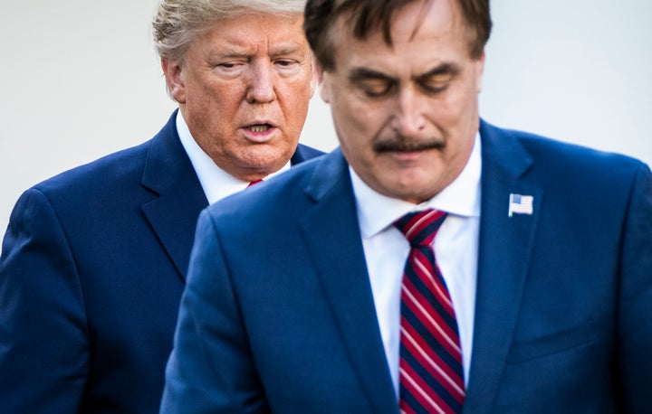Then-President Donald Trump listens to My Pillow CEO Mike Lindell speak with members of the coronavirus task force and reporters outside the White House in 2020.
