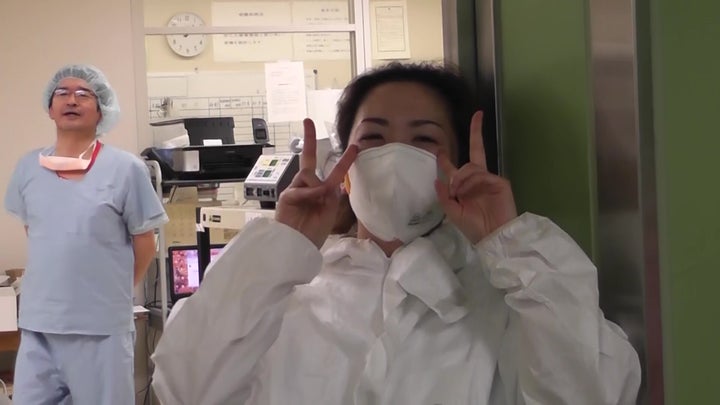 Hospital staff wearing protective suits.