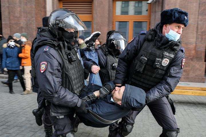 Russian police officers detain a man during an unsanctioned protest rally against the military invasion in Ukraine on March 6, 2022 in Moscow.