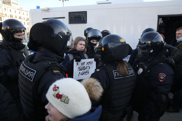 A Russian police officer detain a woman holding the poster reads: "I do not want to kill anyone" during an unsanctioned protest rally against the military invasion on Ukraine.