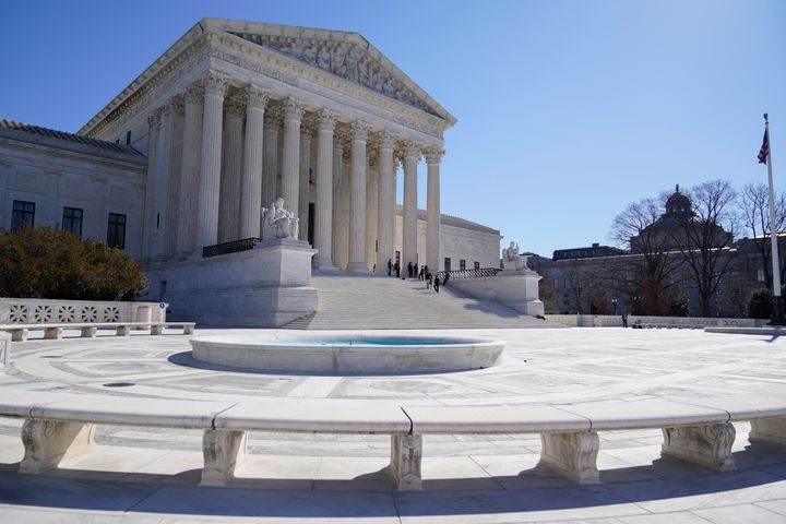 People stand on the steps of the U.S. Supreme Court, Feb.11, 2022, in Washington. (AP Photo/Mariam Zuhaib, File)