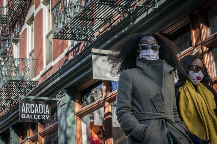 Pedestrians wearing protective masks walk along West Broadway in the SoHo district of New York on March 4. Mayor Eric Adams announced in a morning news conference that the city will be scaling back of COVID-19 mask and vaccine mandates.