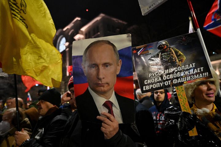 A man holds a portrait of Vladimir Putin during a rally organised by Serbian right-wing organisations in support of Russia's invasion in Ukraine, in Belgrade on March 4, 2022.