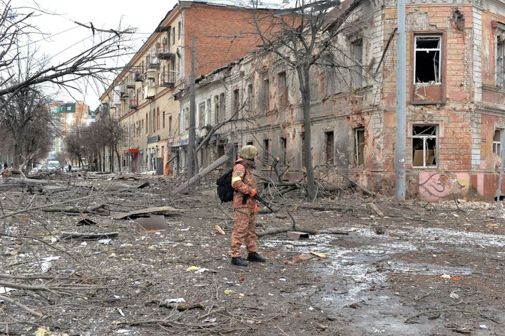A member of the Ukrainian Territorial Defense Forces looks at destruction following a shelling in Ukraine's second-biggest city, Kharkiv, on Monday.