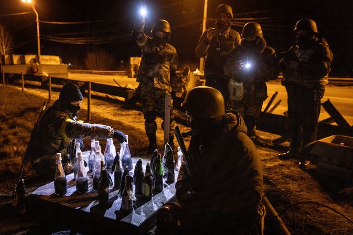 Ukrainian soldiers play checkers with Molotov cocktails in Kyiv.