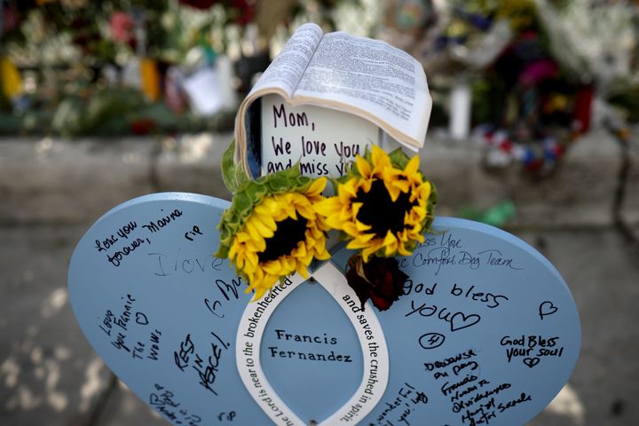Notes are written on a makeshift headstone for Francis Fernandez, a victim of the Champlain Towers South condo collapse on June 24, 2014, in Surfside, Florida.