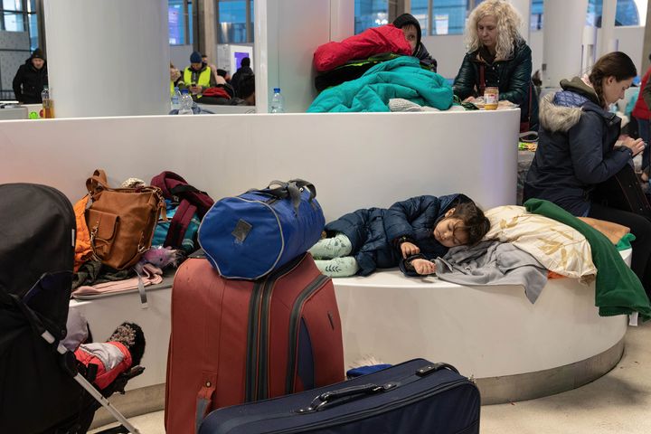 A young girl seen sleeping in Warszawa Centralna Railway Station after fleeing from the war in Ukraine.