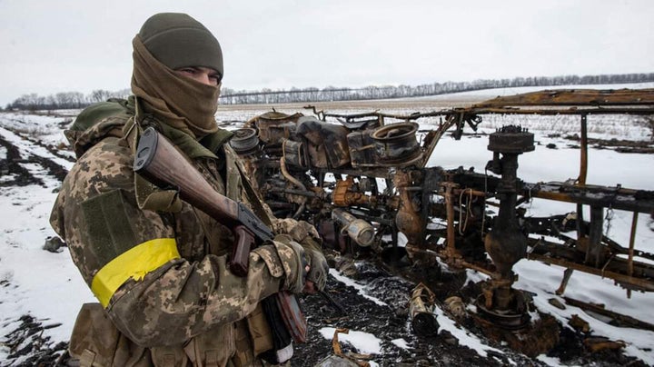 A Ukrainian serviceman of the 93rd Independent Kholodnyi Yar Mechanized Brigade examining a destroyed military vehicles in an unknown place in Ukraine. 