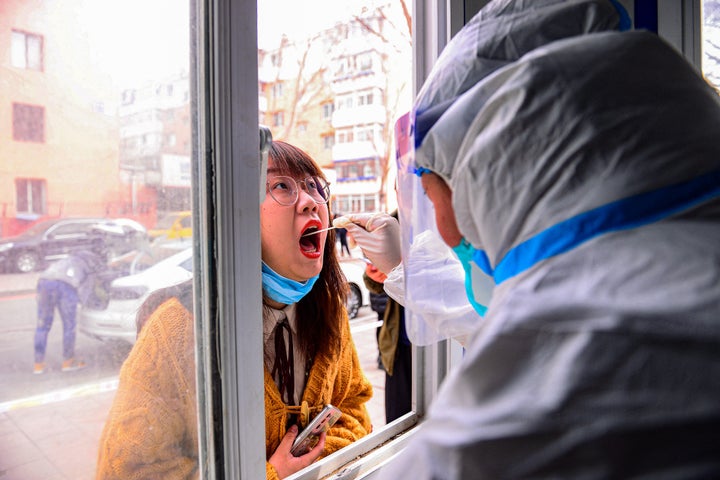 A resident undergoes a nucleic acid test for the Covid-19 coronavirus in Shenyang in China's northeastern Liaoning province on March 9, 2022.