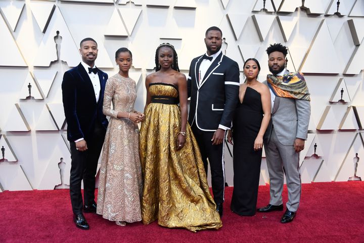 Ryan posing with his wife, Zinzi Evans, and the cast of Black Panther at the 2019 Oscars
