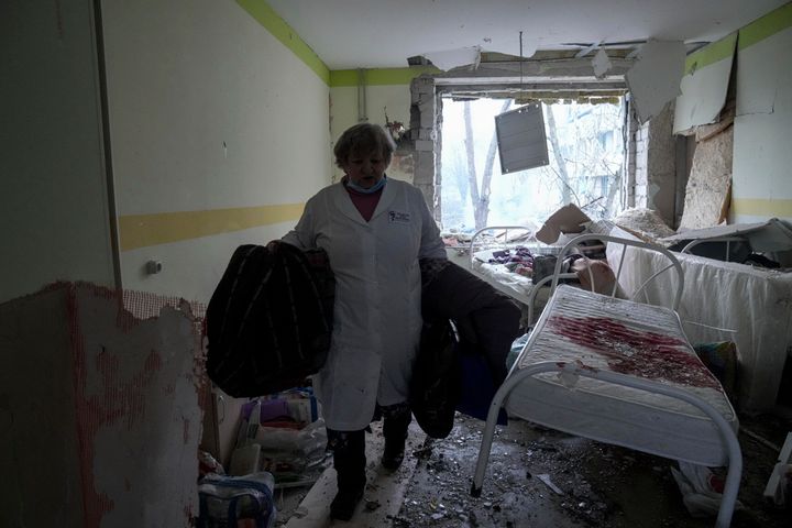 A medical worker walks inside of the damaged by shelling maternity hospital in Mariupol, Ukraine.