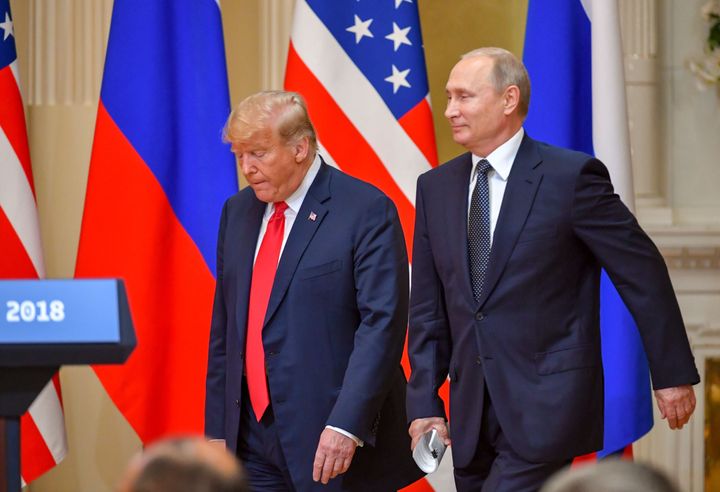 Then-President Donald Trump and Russian President Vladimir Putin arrive to attend a joint press conference after a meeting at the Presidential Palace in Helsinki, on July 16, 2018.