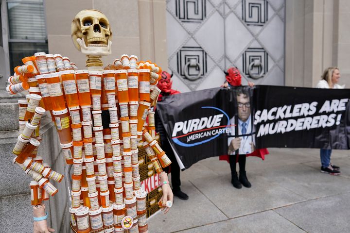 "Pill Mann," made from a Massachusetts man's opioid prescription pill bottles, is displayed during a protest by advocates for opioid victims outside the Department of Justice in December.