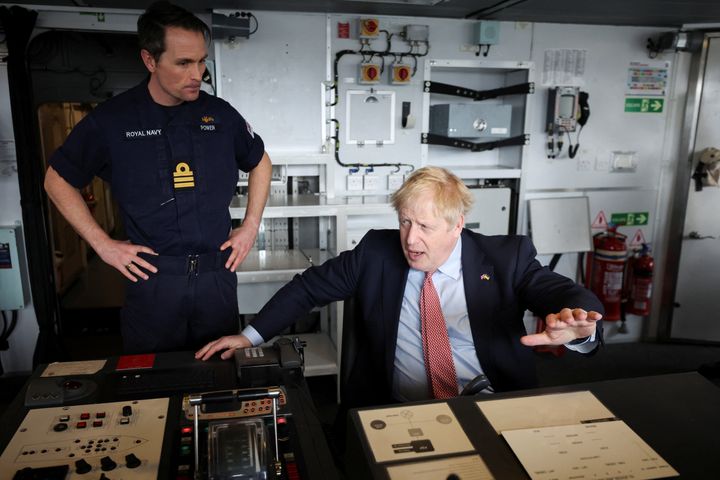 Boris Johnson sits on the bridge of HMS Dauntless, a Type 45 air-defence destroyer of the Royal Navy.