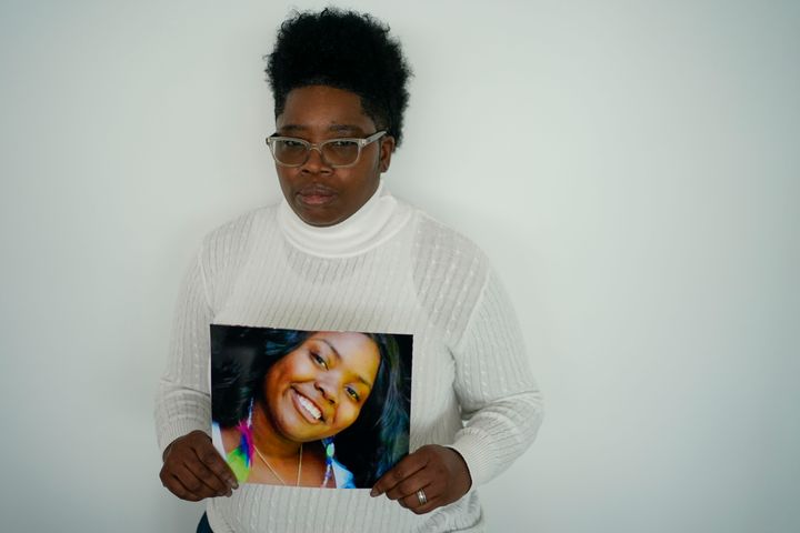 Tiffinee Scott poses for a picture with a photo of her daughter, Tiarra, after making a statement on Thursday.