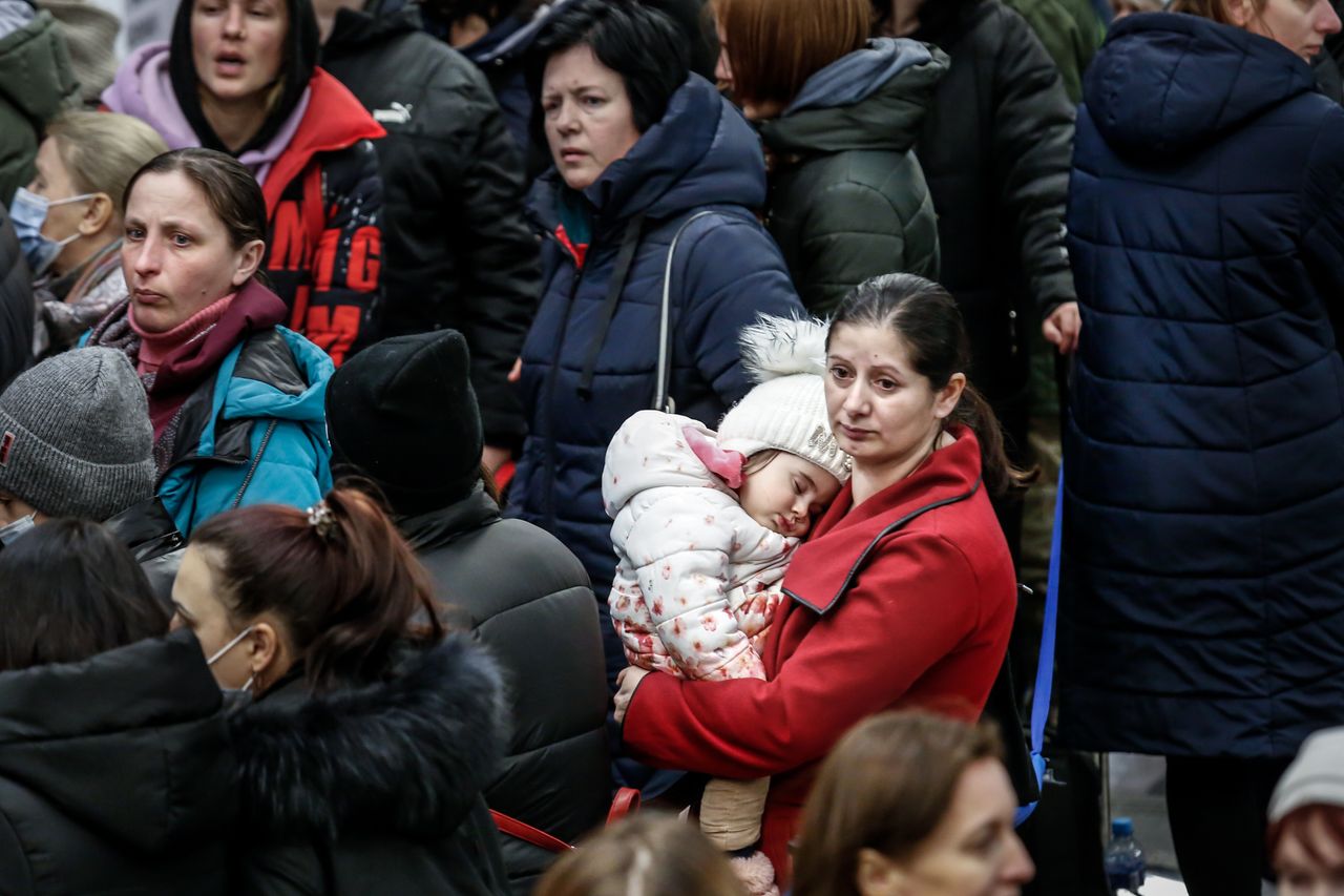Ukrainian refugees queue to be registered after arriving in Krakow as millions flee Ukraine - March 10, 2022. 