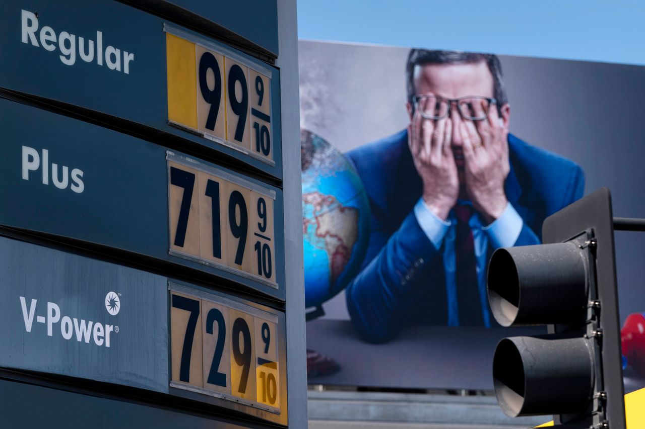 Gas prices are seen in front of a billboard advertising HBO's "Last Week Tonight" in Los Angeles on Monday.