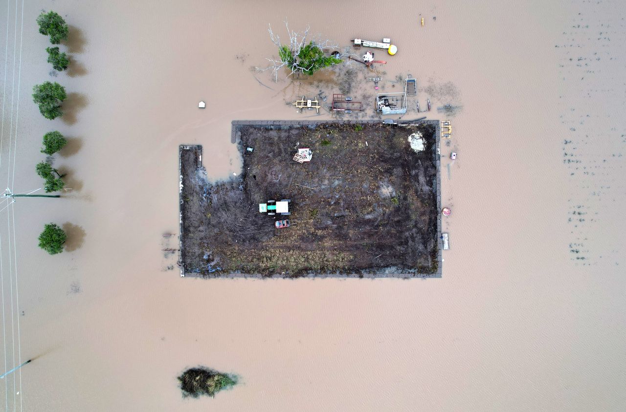 A tractor rests on a small paddock surrounded by floodwater on Monday in Brisbane, Australia. Residents of northern New South Wales are still cleaning up following unprecedented storms and the worst flooding in a decade. 