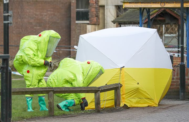 Personnel in hazmat suits working to secure a tent covering a bench in the Maltings shopping centre in Salisbury where former Russian double agent Sergei Skripal and his daughter, Yulia, were found critically ill.