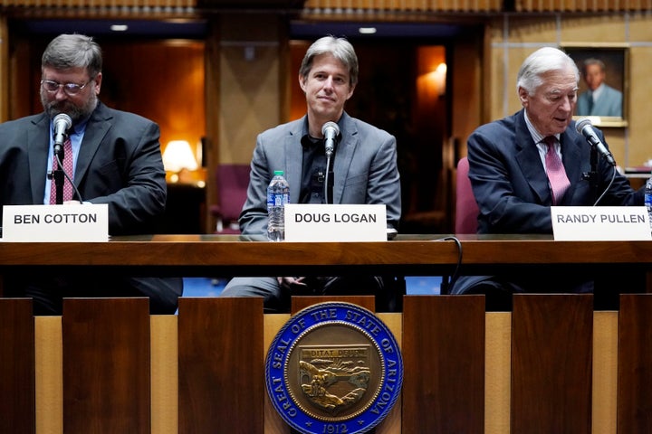 Then-Cyber Ninjas CEO Doug Logan, center, is flanked by Ben Cotton, left, founder of digital security firm CyFIR, and Randy Pullen, right, the former chairman of the Arizona Republican Party, prior to Arizona Senate Republicans hearing a review of the 2020 presidential election results in Maricopa County on Sept. 24, 2021, in Phoenix. 