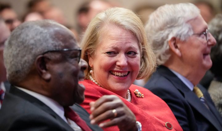 Supreme Court Justice Clarence Thomas shares a laugh with his wife, conservative activist Virginia Thomas, while he waits to speak at the Heritage Foundation last year in Washington, D.C. 
