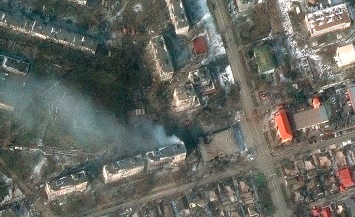 This satellite image provided by Maxar Technologies shows burning apartment buildings on Zelinskovo Street in western Mariupol, Ukraine, Saturday, March 12, 2022. (Satellite image ©2022 Maxar Technologies via AP)