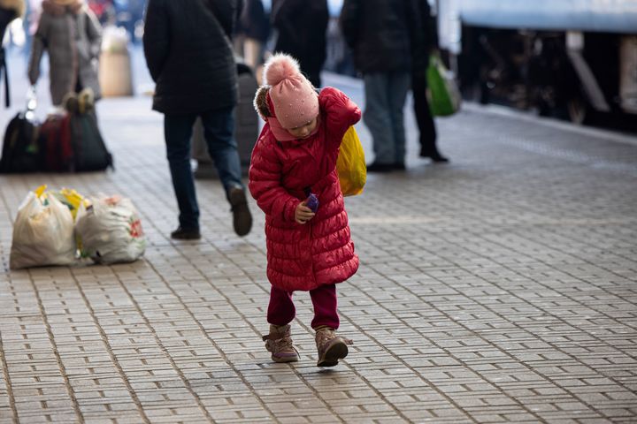 A young child is moves belongings at the platform at the Lviv train station. (Photo by Hesther Ng/SOPA Images/LightRocket via Getty Images)