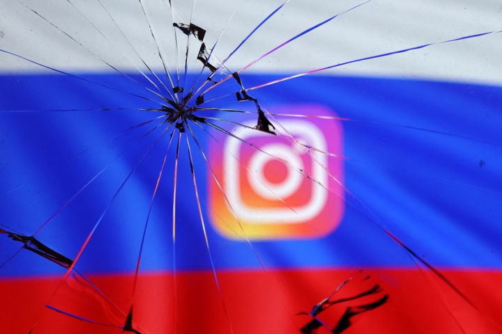 Russian flag and Instagram logo are seen through broken glass in this illustration taken March 11, 2022. REUTERS/Dado Ruvic/Illustration