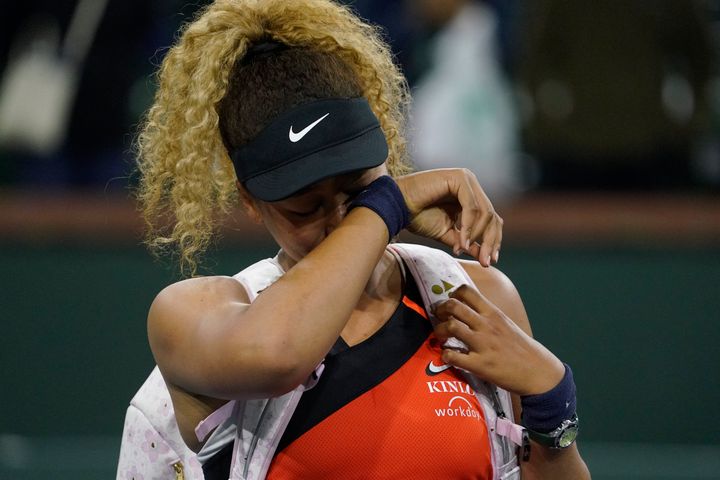 Naomi Osaka, of Japan, wipes away tears as she leaves the court after losing her match to Russia's Veronika Kudermetova at the BNP Paribas Open tennis tournament in Indian Wells, California.