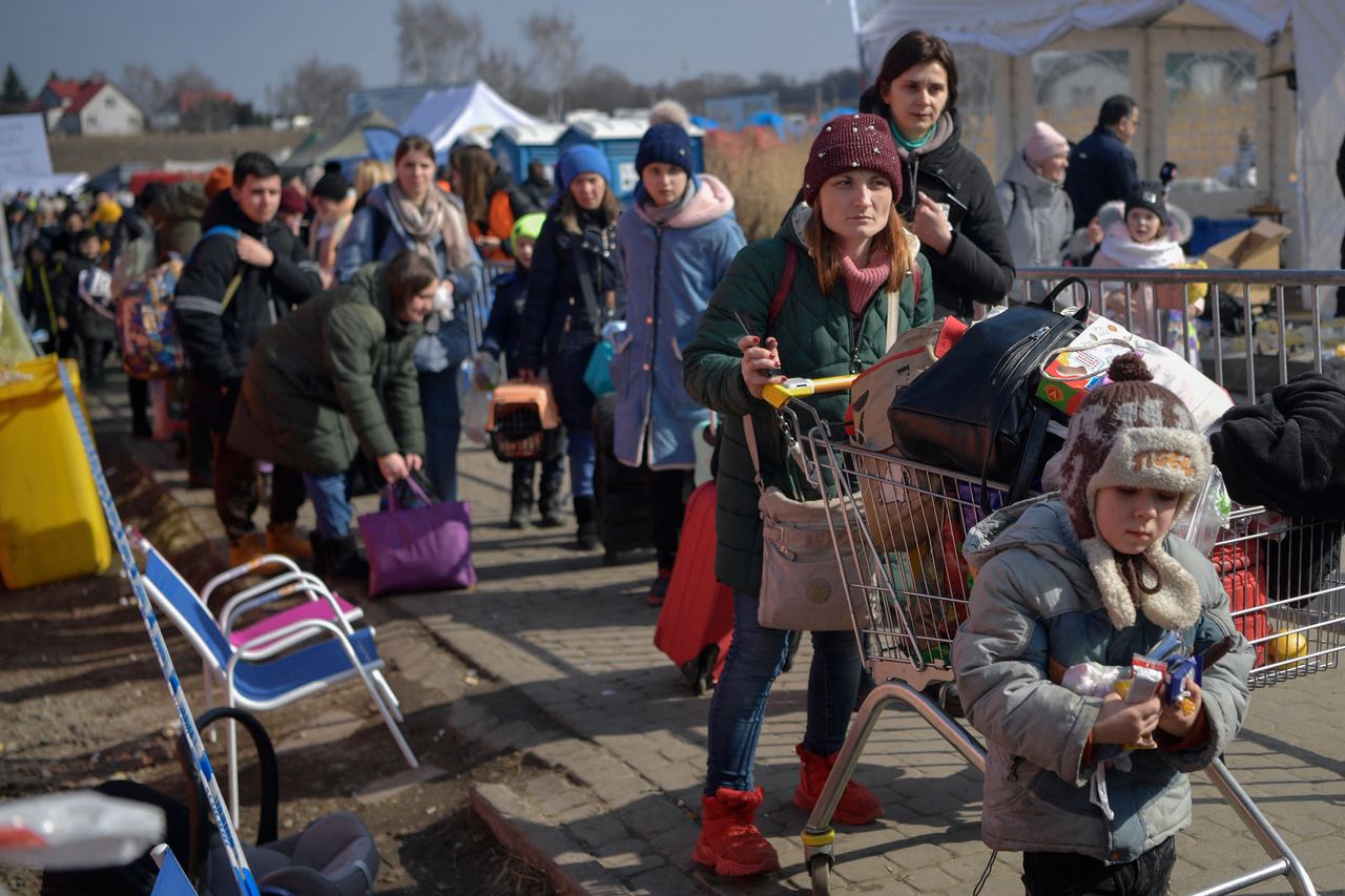 People cross the Ukrainian border into Medyka, southeastern Poland, on March 13, 2022. The number of refugees fleeing Ukraine since the Russian invasion launched is now nearly 2.7 million, the UN said on Sunday.
